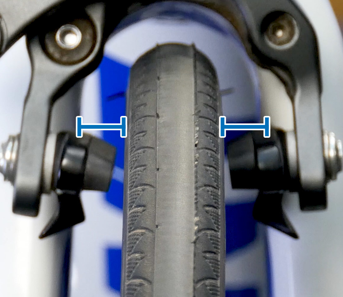 Head-on view of road bike wheel showing even spacing between sides of bicycle fork