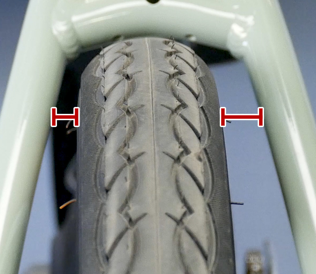 Head-on view of wheel showing uneven spacing between sides of bicycle fork