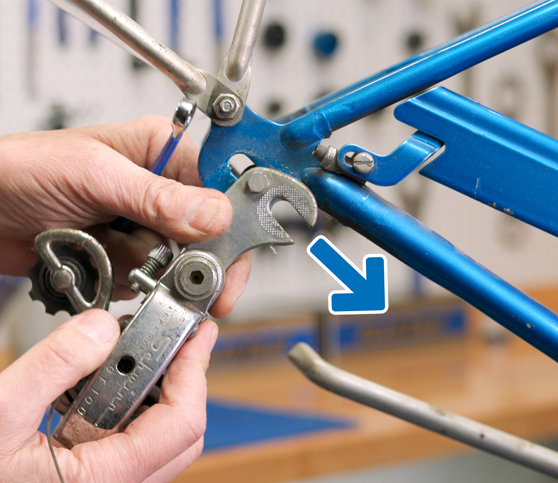 With the mounting bolt loose, simply slide the derailleur bracket out of the dropout