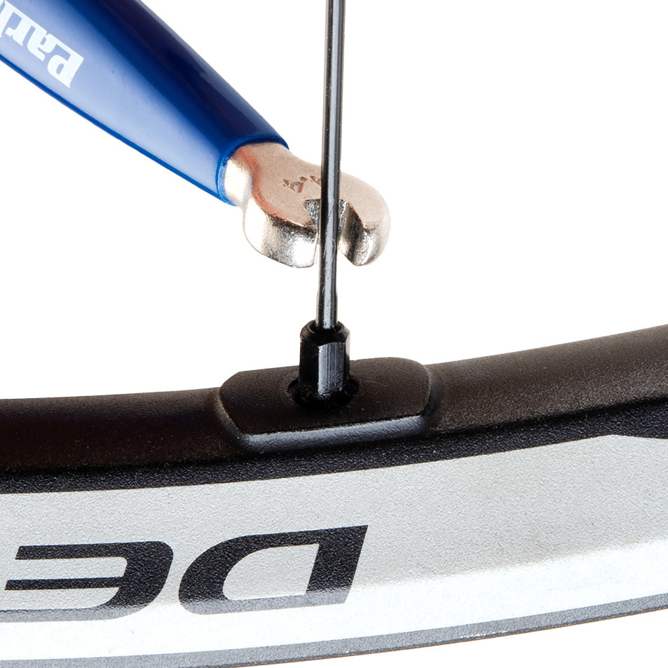 SW-14.5 double-ended spoke wrench being fitted to square Shimano® spoke nipple on wheel