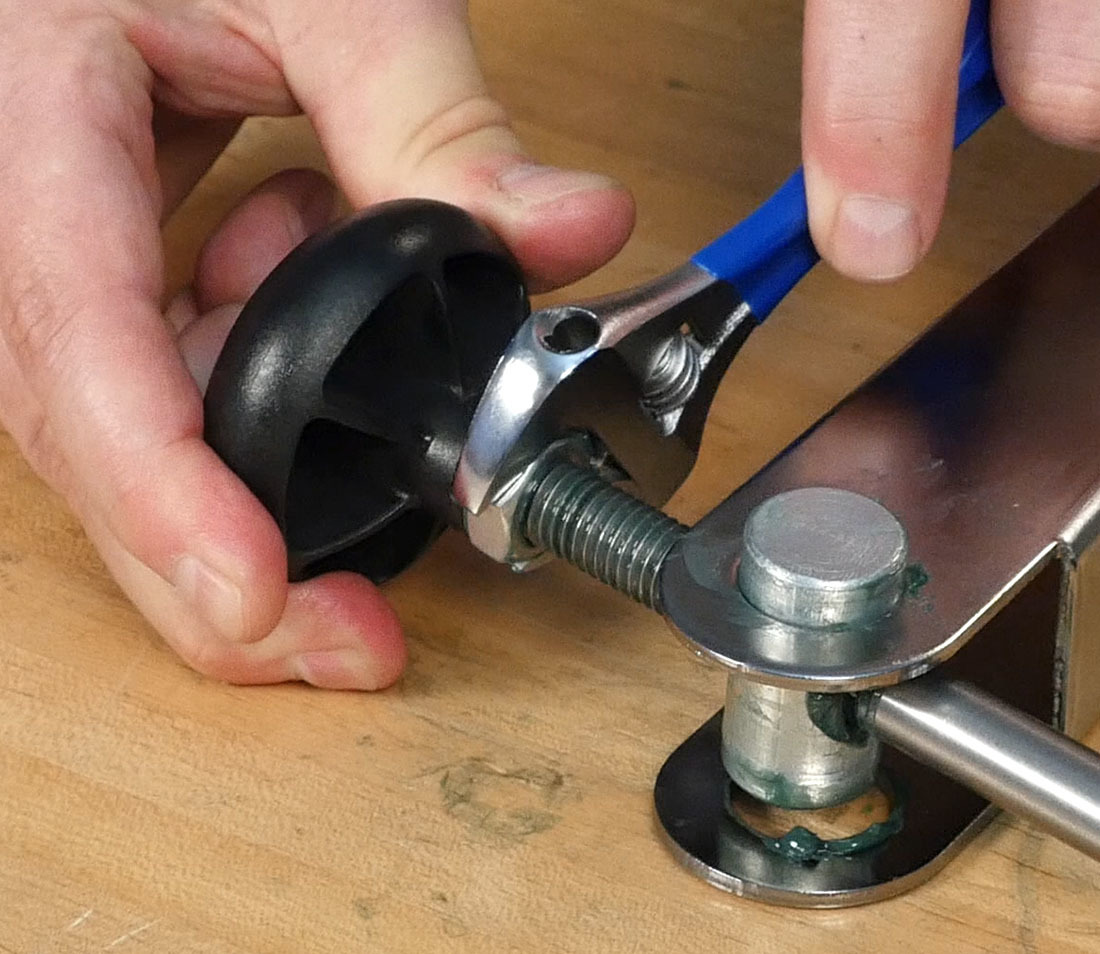 Use a wrench to snug the locknut against the knob