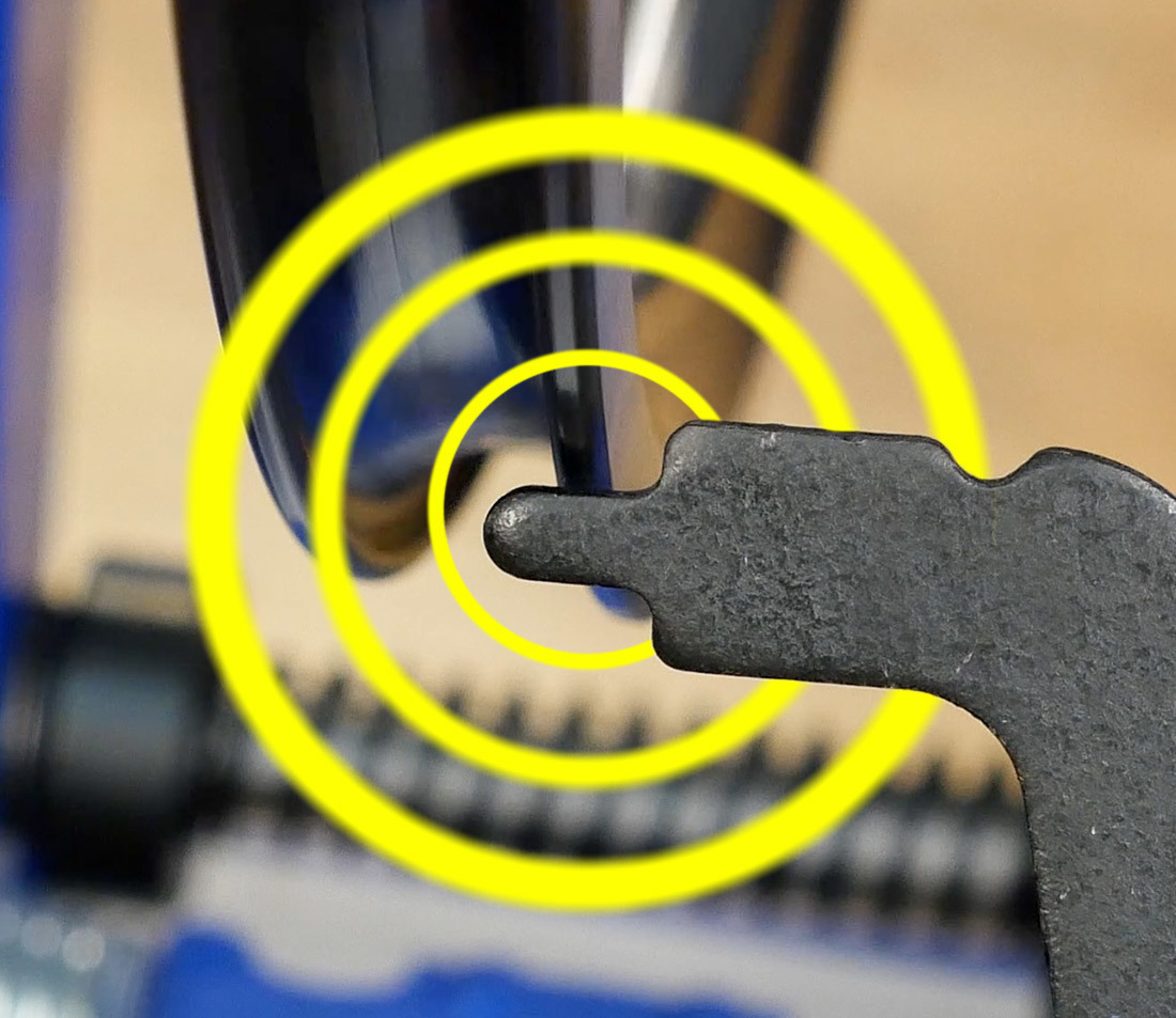 Truing stand making contact with bottom of bicycle rim