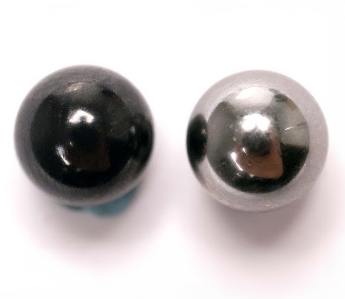 Figure 1. Ceramic 1/4-inch ball on left and a 1/4-inch steel ball on right.