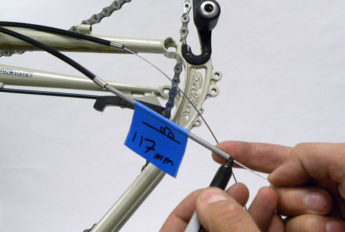 Figure 10. Use scrap housing to measure the correct distance and mark shift wire for cutting