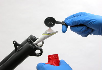Figure 11. Use a small funnel and pour in leg bolt holes 15ml (1 tablespoon) suspension fluid