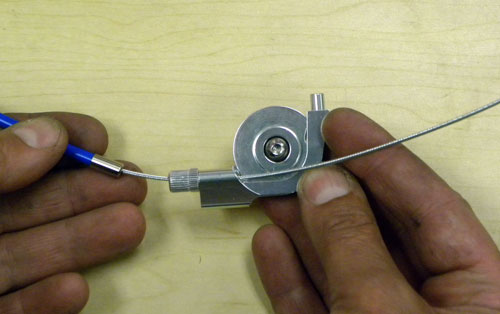 Route barrel adjuster (if any) and cable through hole aligned with smaller inner pulley